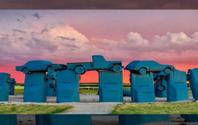 Carhenge’s upright and stacked automobiles beneath a colorful Nebraska sky